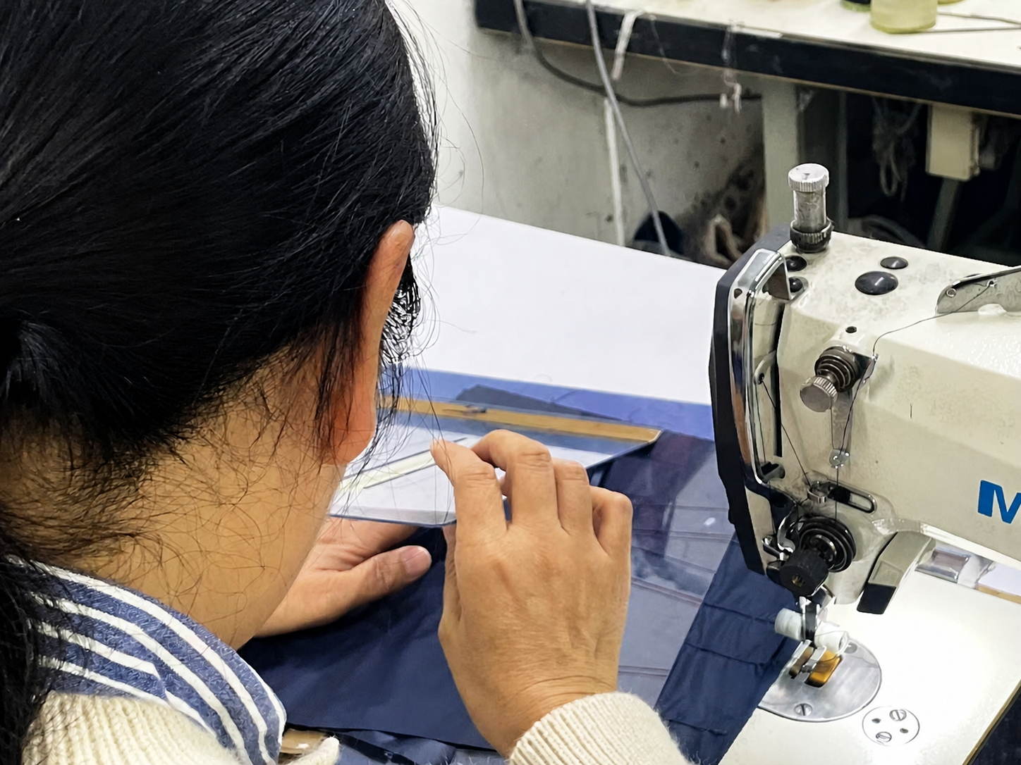 Sample room specialist aligning garment panels before construction
